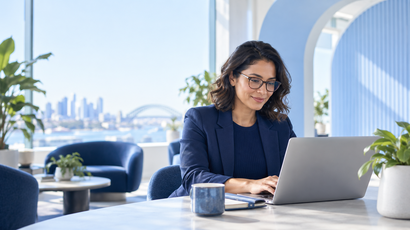 A hiring professional with glasses reviewing applications at a laptop